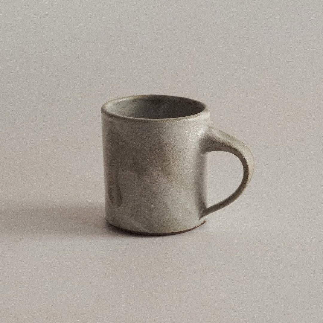Gray ceramic mug on a plain background